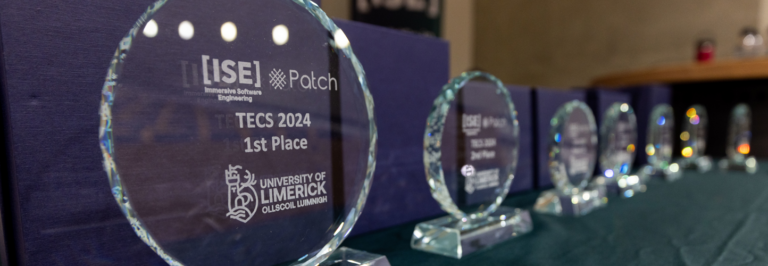 Glass trophies from TECS competition featuring logos for Immersive Software Engineering, Patch and the University of Limerick.